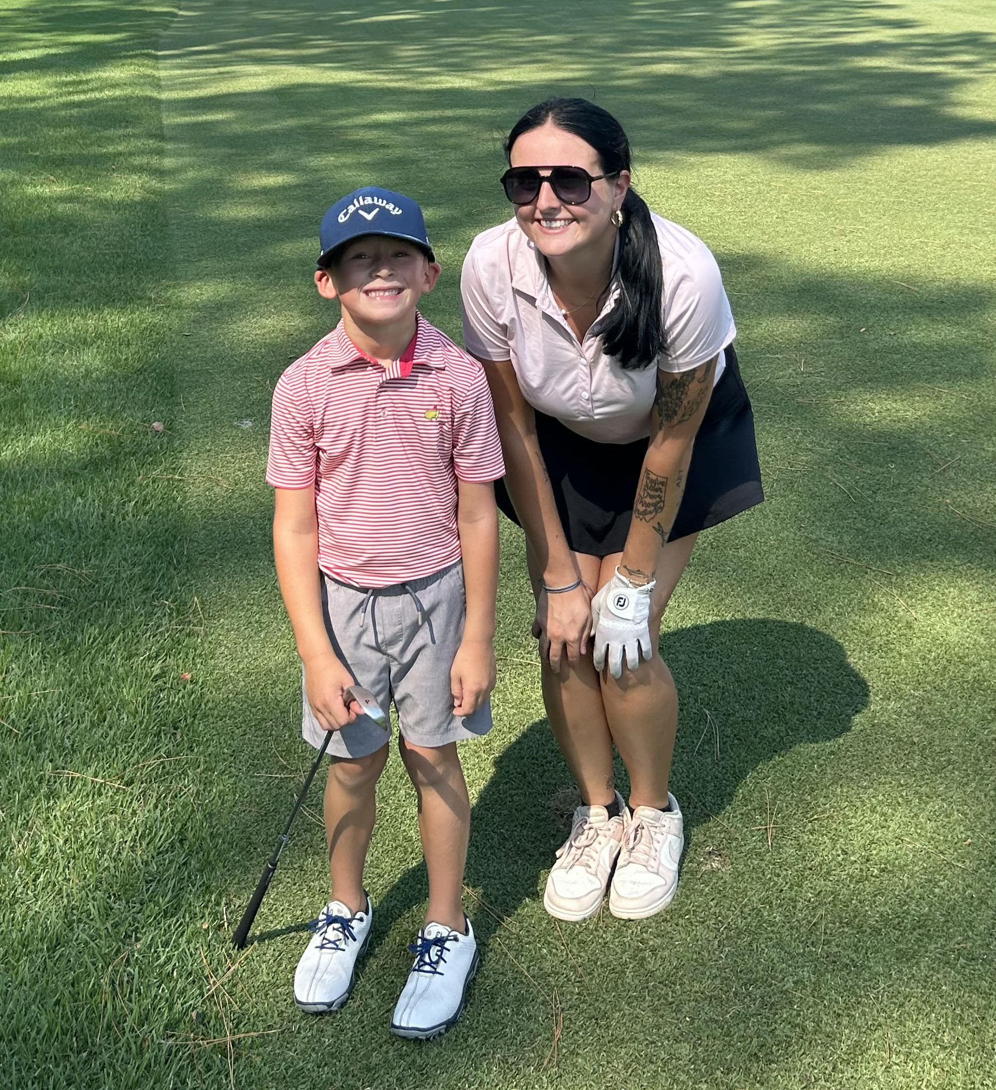 Brianna Fisher with junior golfer